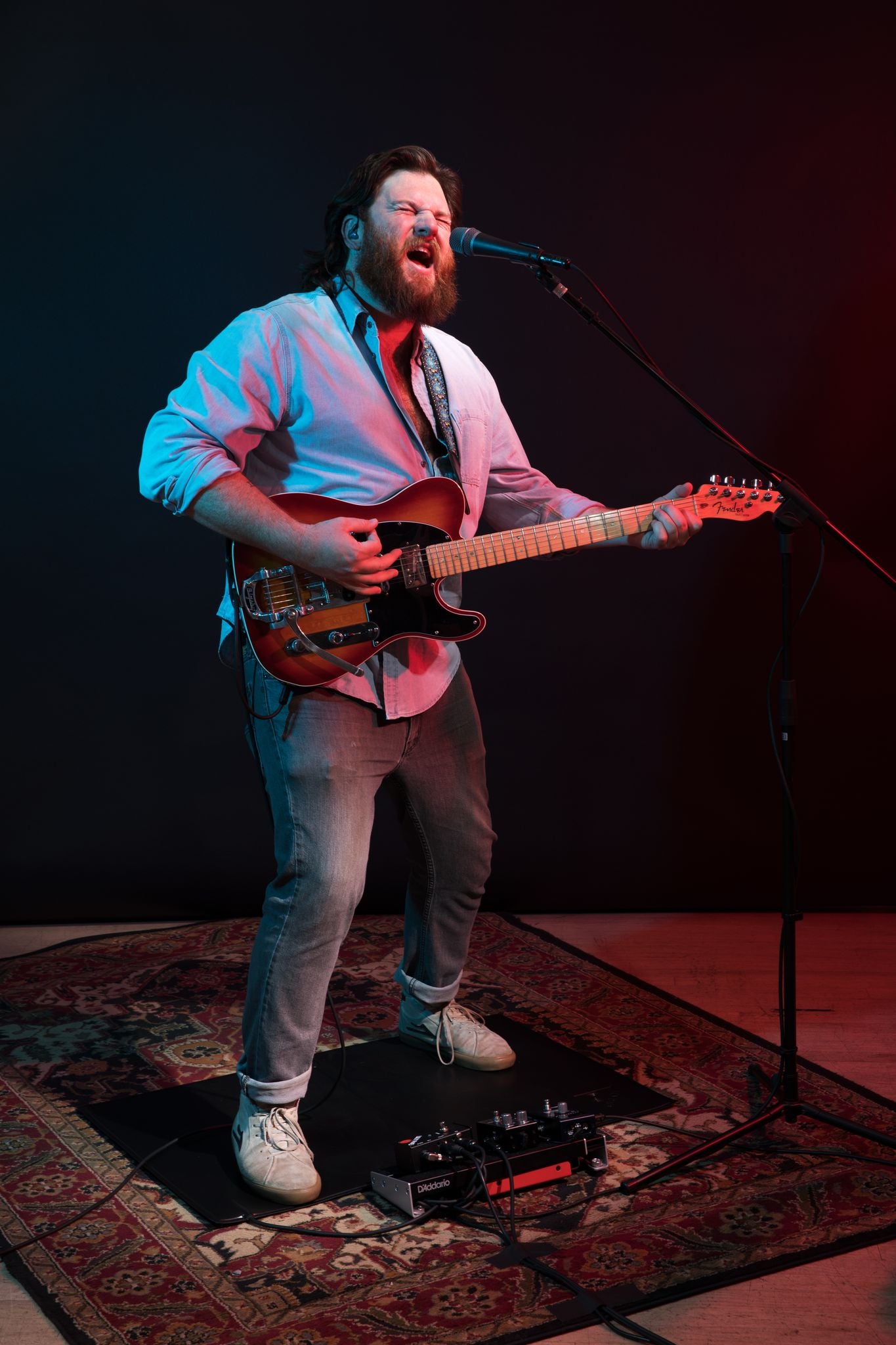 Andrew Cooney sings into microphone connected to lily p4d arena ducking system