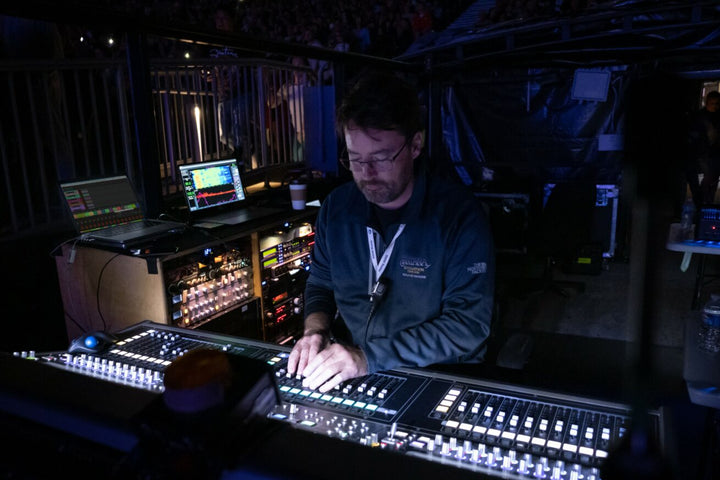Front of house engineer Kevin Madigan mixes the sound for Carlos Santana